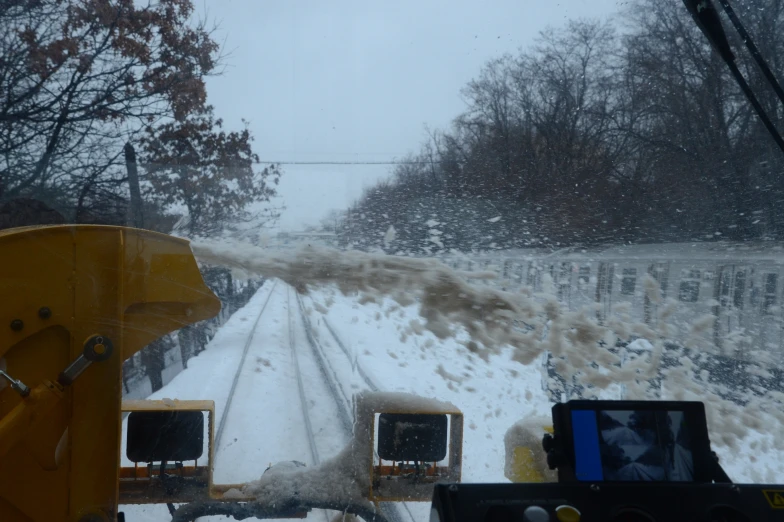 a snow plow is making its way down the road