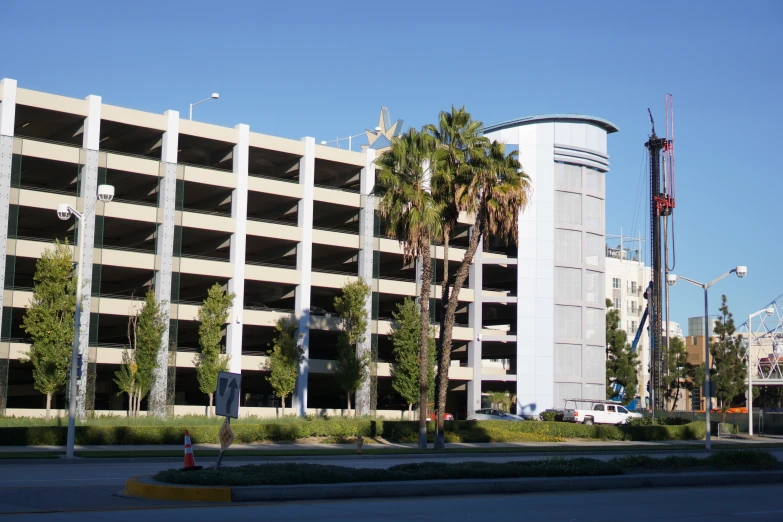 a parking garage sits on the side of a tall white building