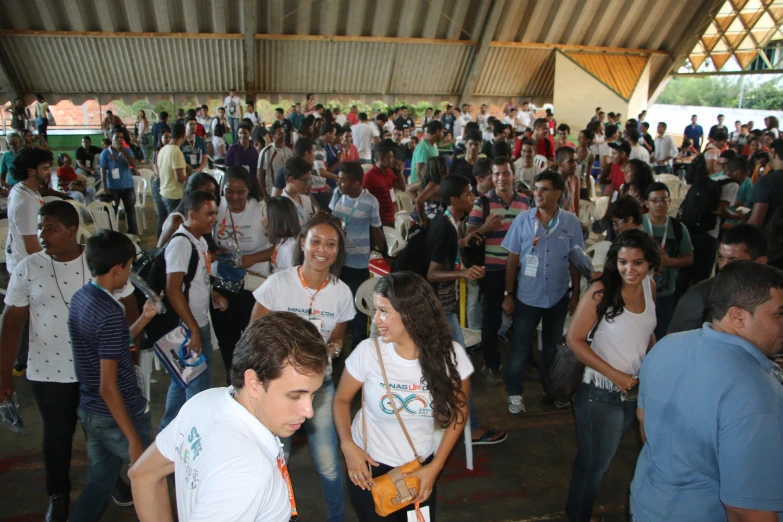 a group of people are walking through an area with people all around them