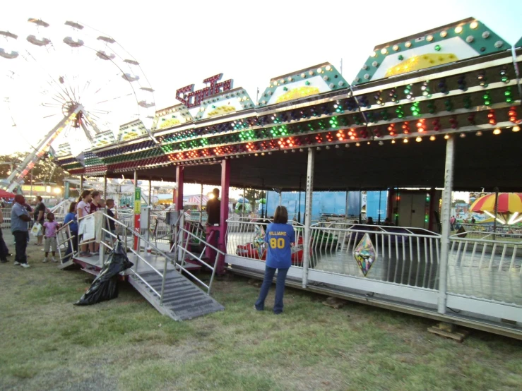 a carnival with some rides and a ferris wheel