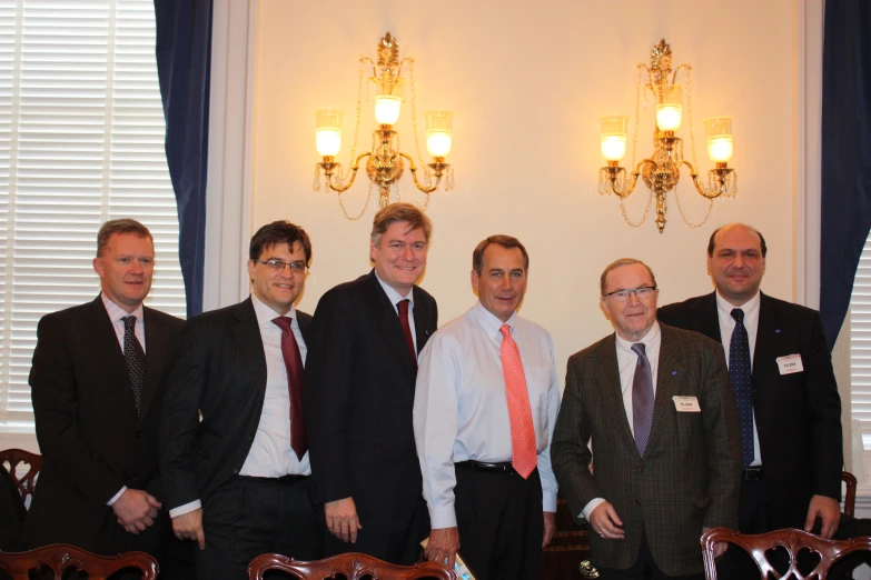 there are seven men in suits and ties posing for the camera