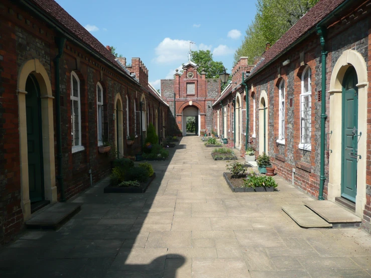 a row of old brick buildings with potted plants