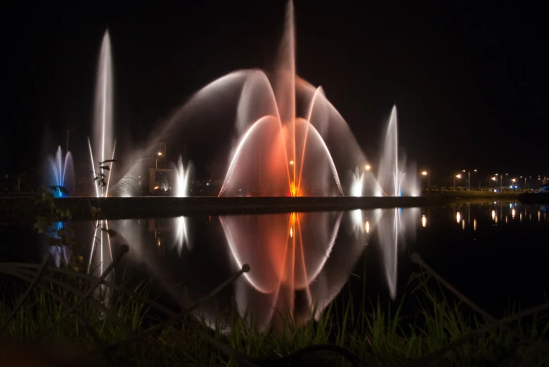 colorful water fountains in the night time light up