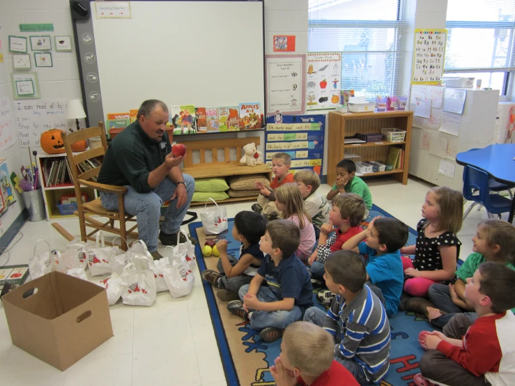 a man reading to a bunch of children