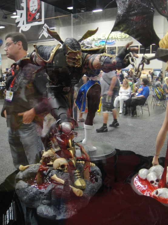 two men wearing costumes stand next to a display