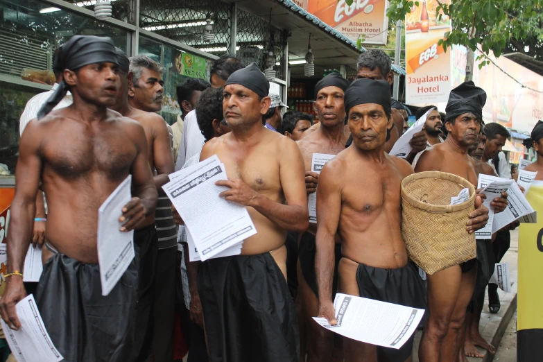 a group of men with hats and s are holding papers