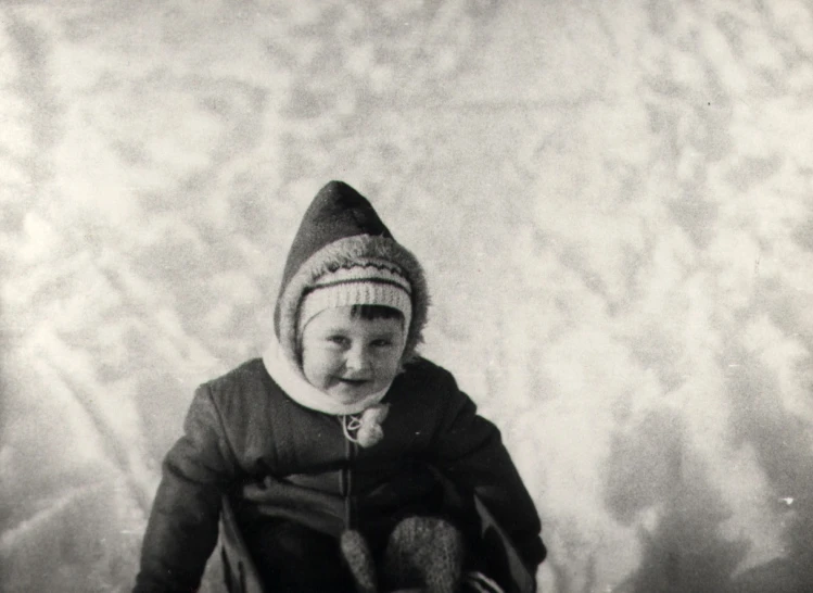 black and white po of young child holding stuffed animal