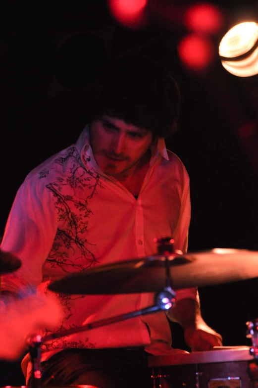 a person playing drums on stage at night