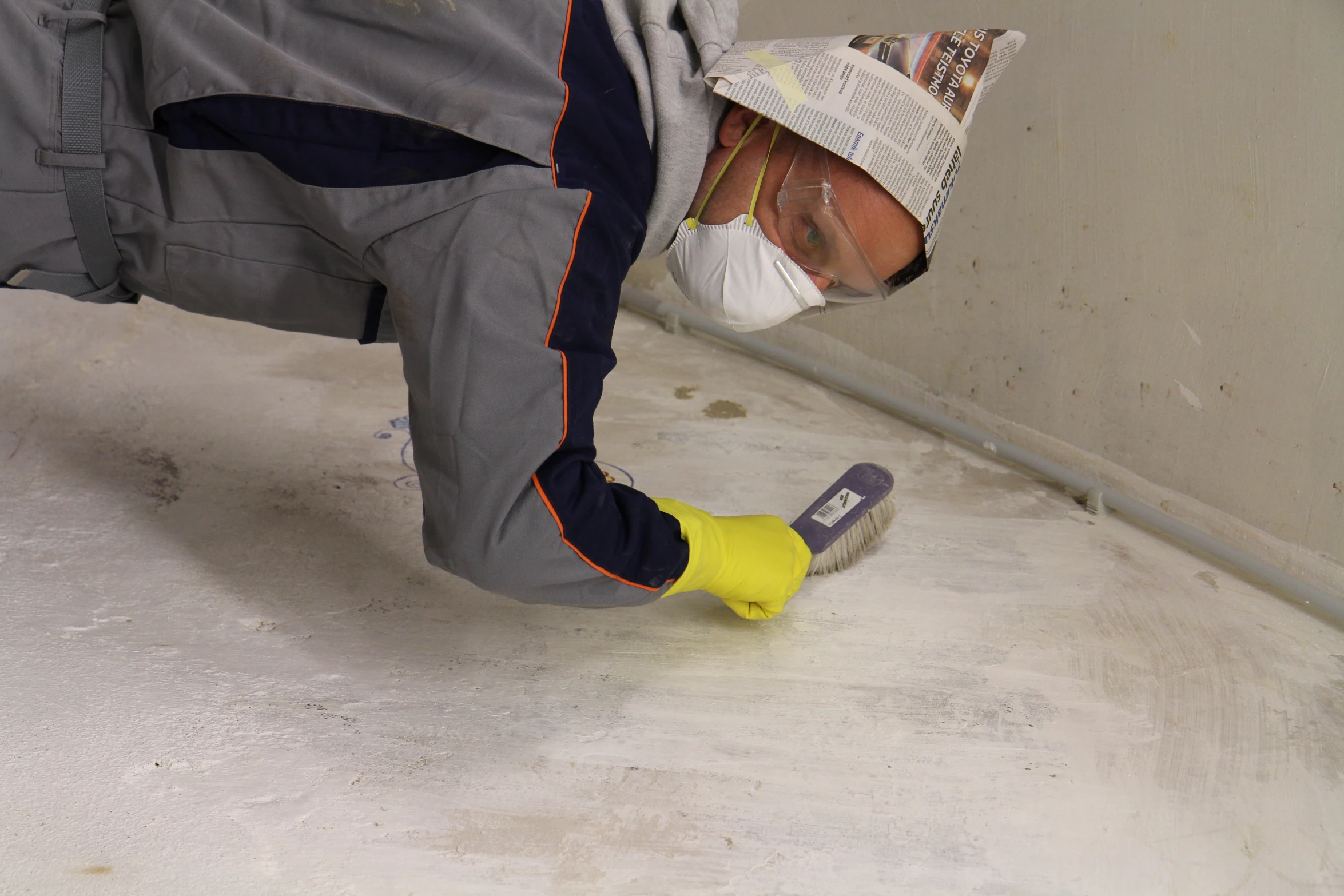 a man with a mask is spray painting a wall