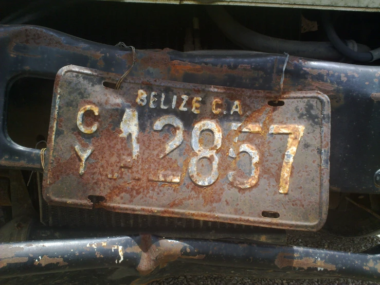a rusty plate reads pelica ca on it