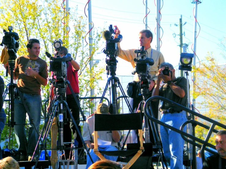 men standing on a set of stairs in front of camera equipment