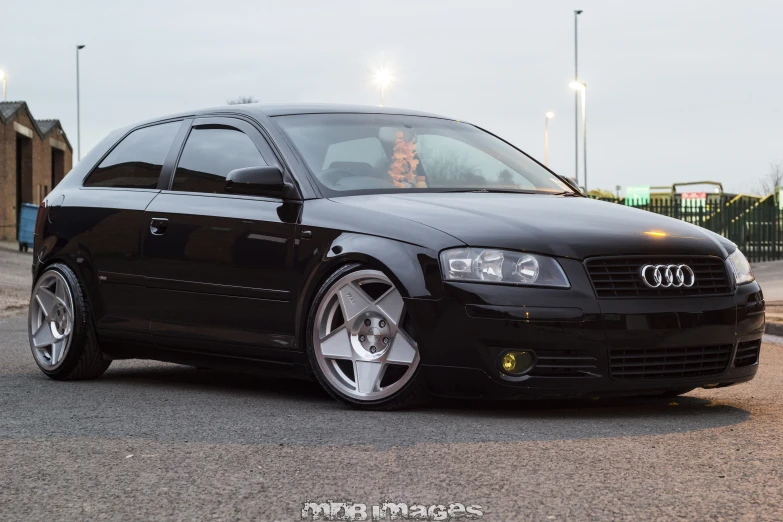 a black car parked in a parking lot