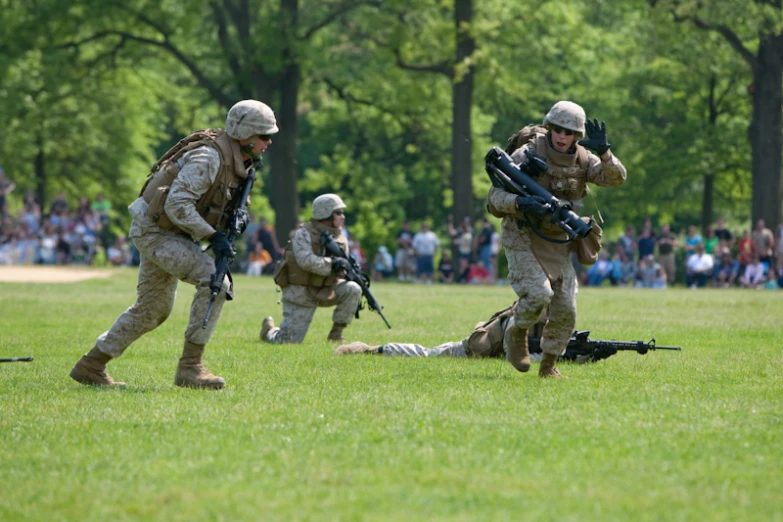 several soldiers with their weapons in action