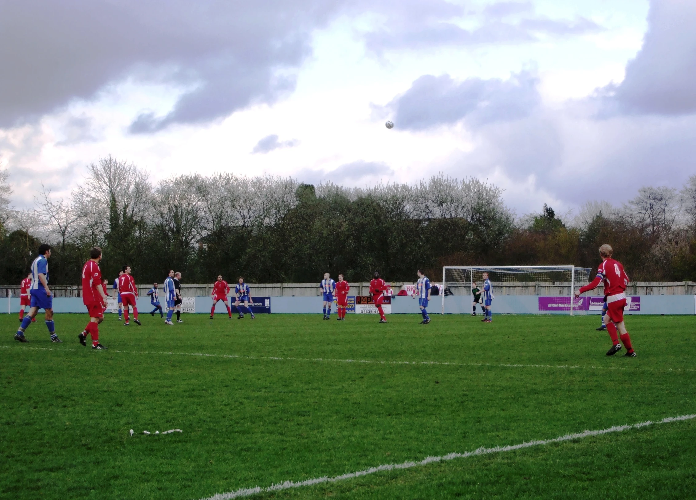 a group of people are playing soccer on a field