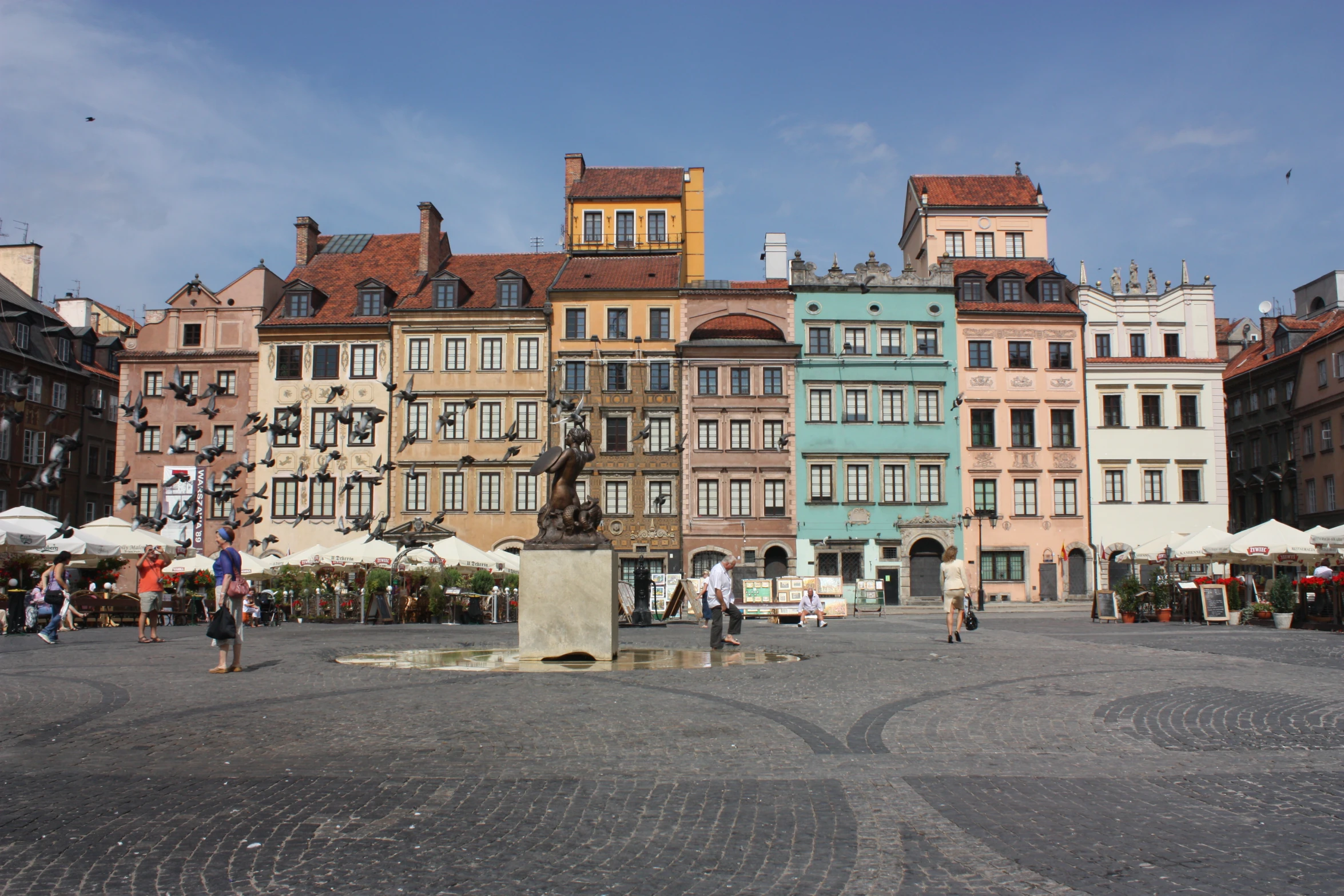 a bunch of different colored buildings on the street