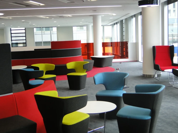 the lobby is decorated in bright colors and bright furniture