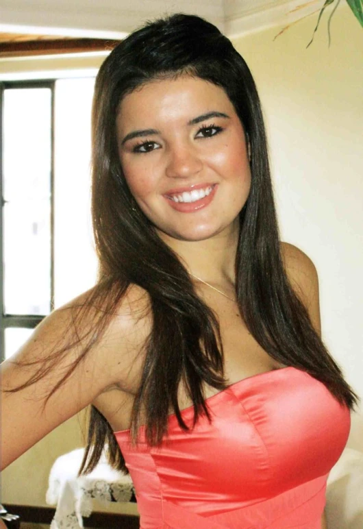 woman in red dress posing for camera in living room