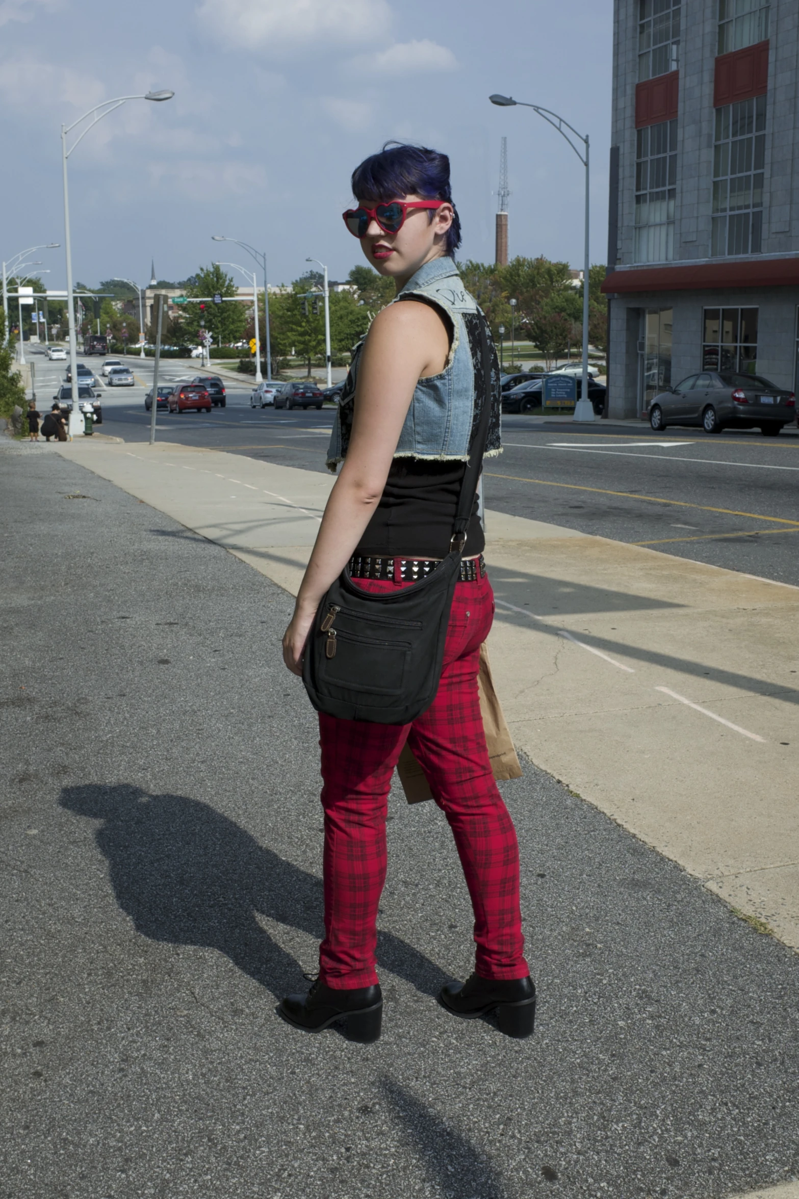 a woman wearing pink leggings walking with her backpack on