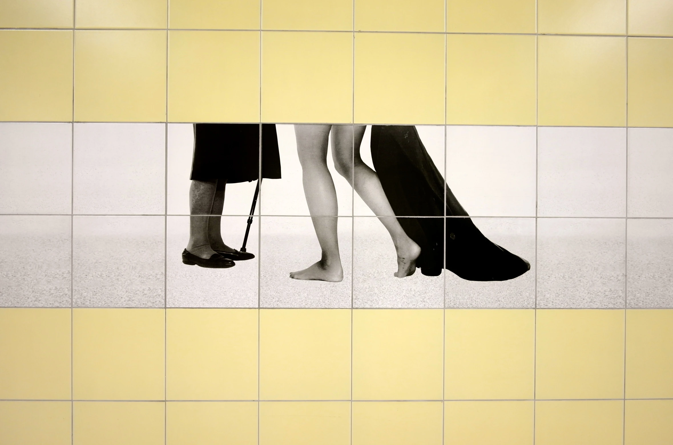 two women standing side by side wearing high heels