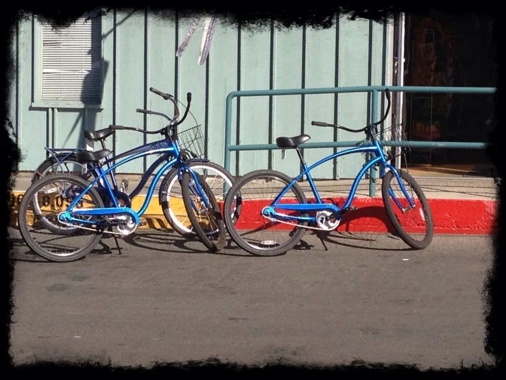a couple of bicycles parked on the side of a street