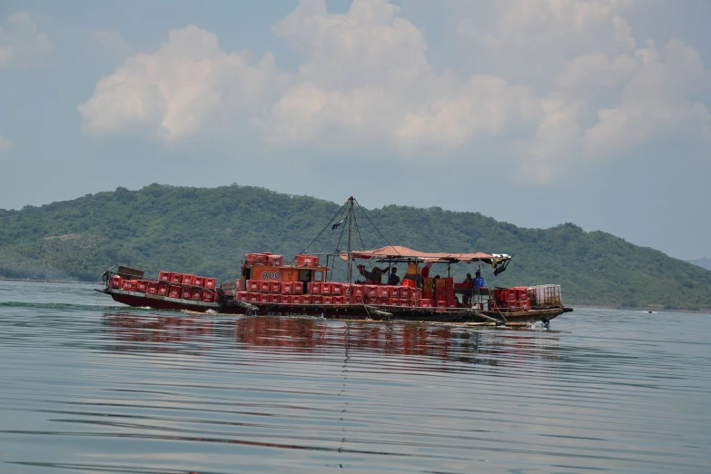 a boat with people is carrying a lot of items