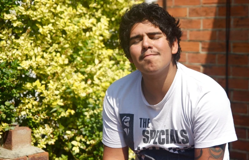 a man sitting down looking sad and pensive