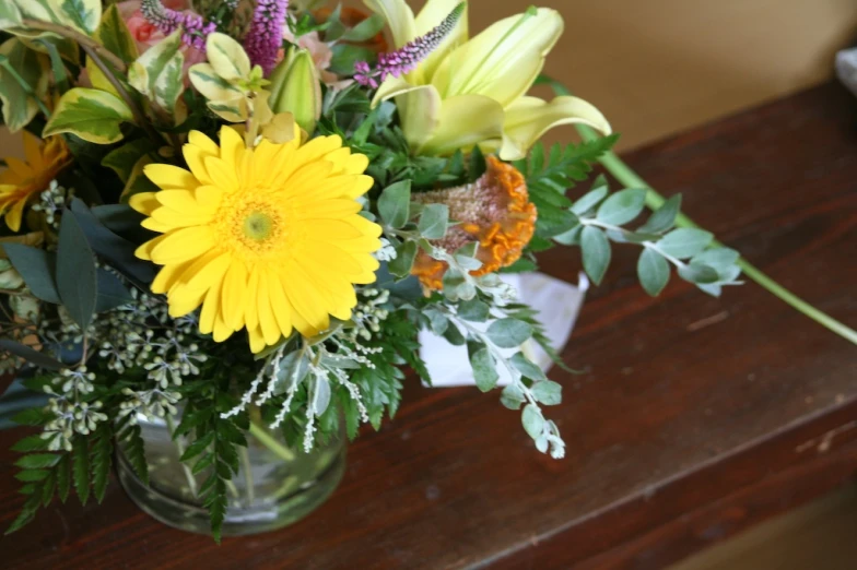 flowers are shown in a small vase on a table