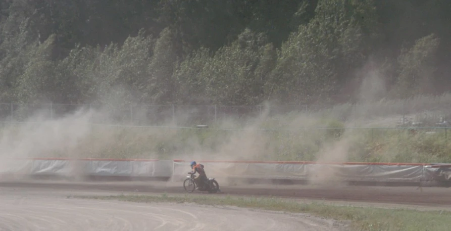 a person riding a motor bike in the dirt