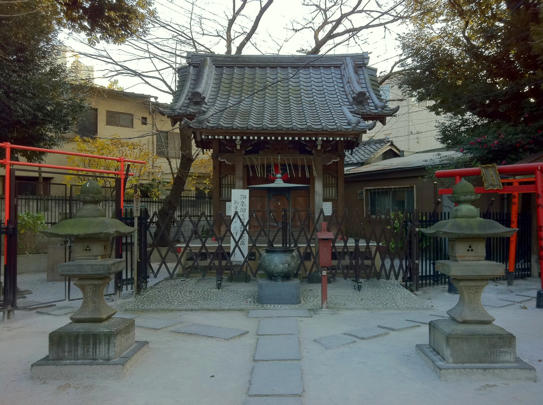 a building is located in a courtyard with statues on the ground