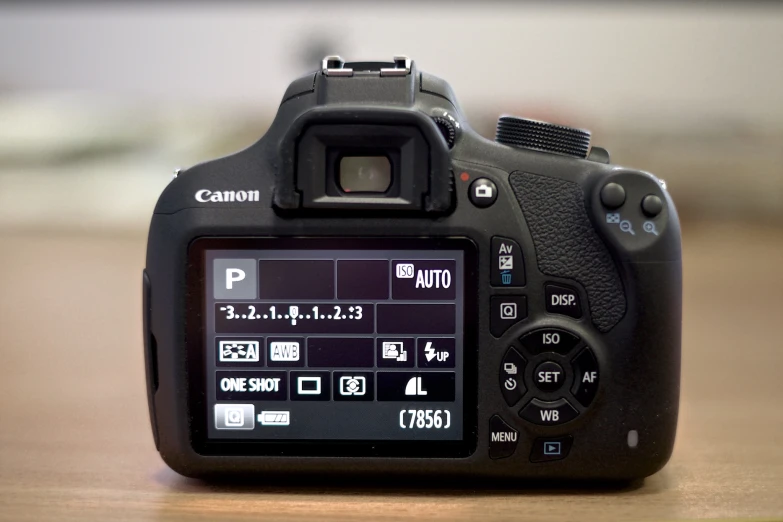 a camera with its lens up is sitting on a table