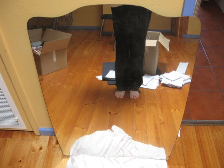 a small child's feet sitting in the middle of a room