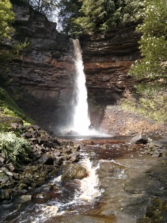 a view of a waterfall from the side in the woods