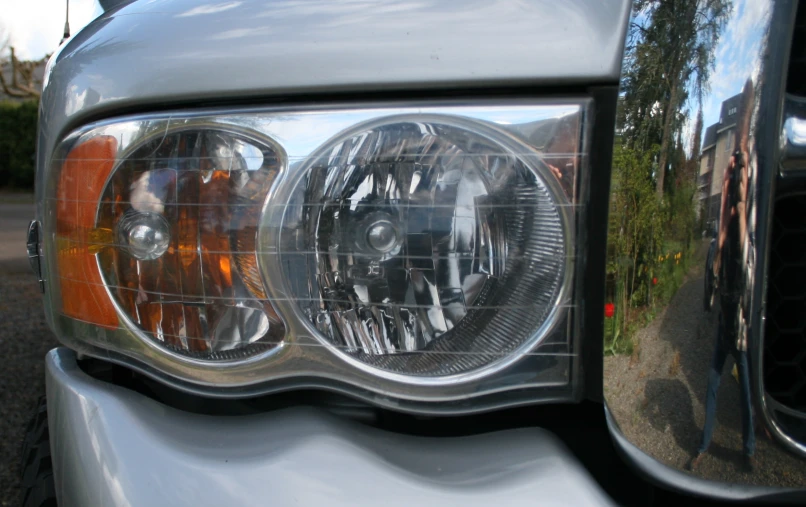 the reflection of a front light on the side of a vehicle