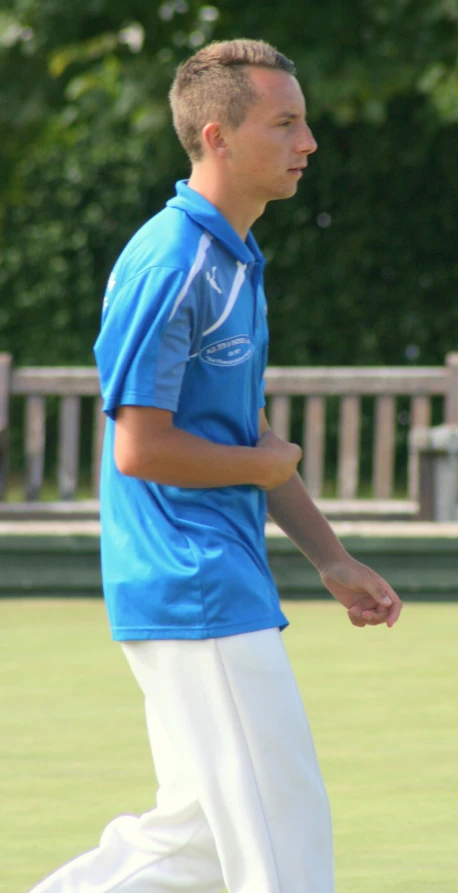 a man on the green with a tennis racquet