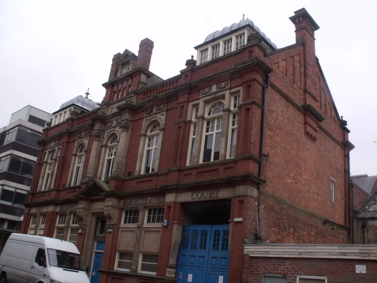 an old red brick building with a blue door