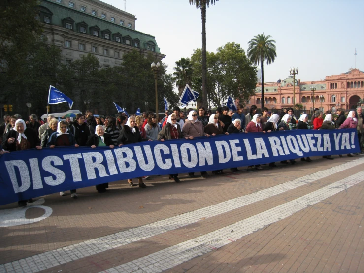 a long blue banner in front of a crowd