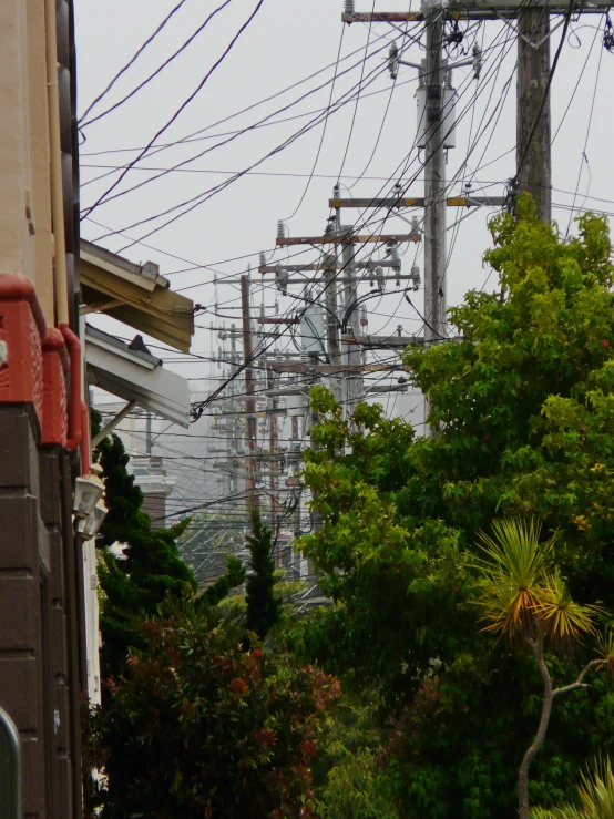 the electrical lines are above a street in the city