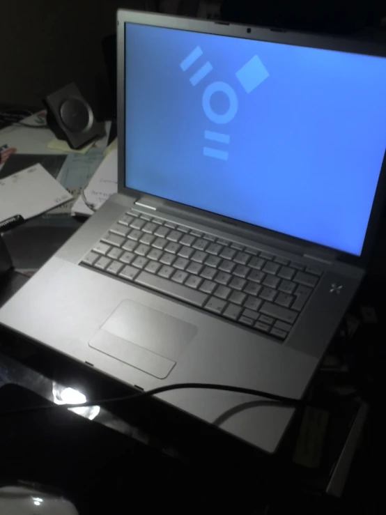 a laptop sitting on top of a desk near a mouse