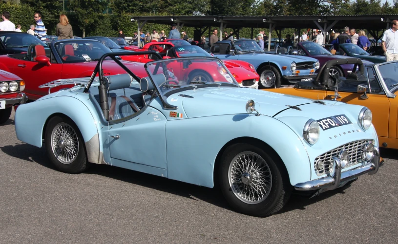 a group of old - fashioned cars on display at an event