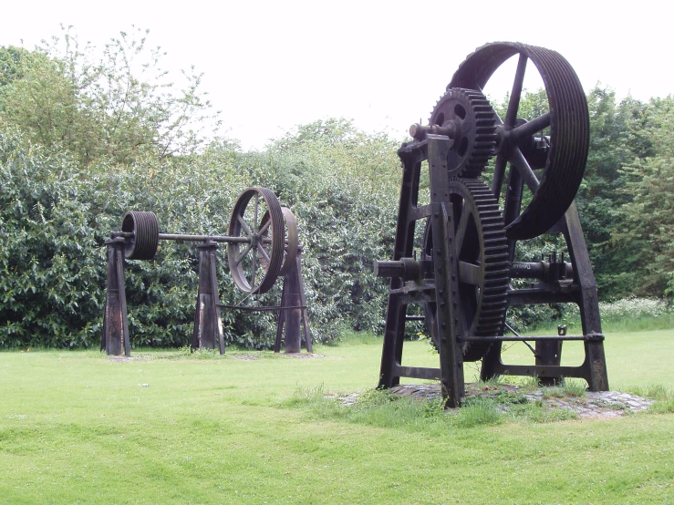 an old metal machine sits in a grassy field