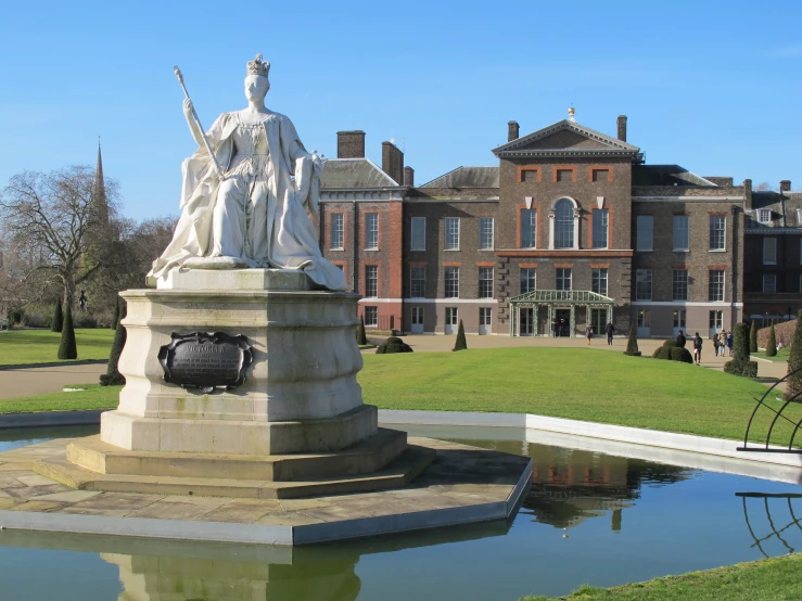 a statue in front of a building that has several windows