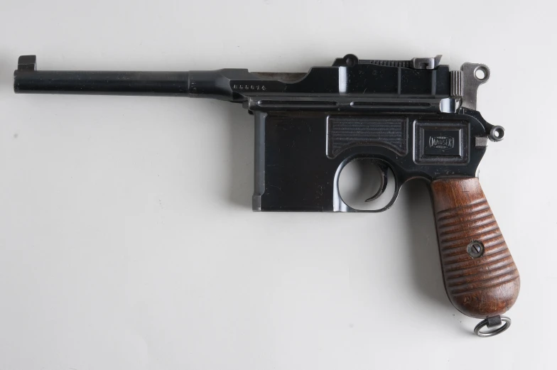 a wooden gun is sitting on the wall