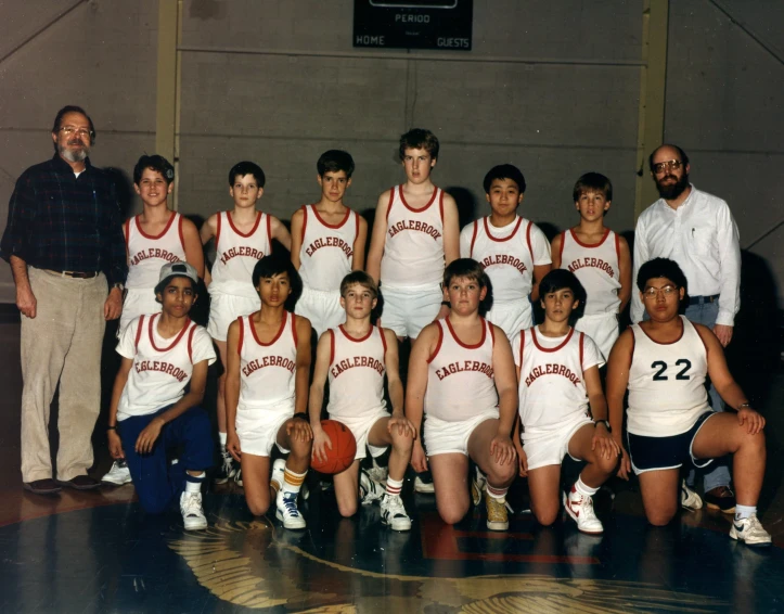 the old po shows basketball players on the court with coach and man in front