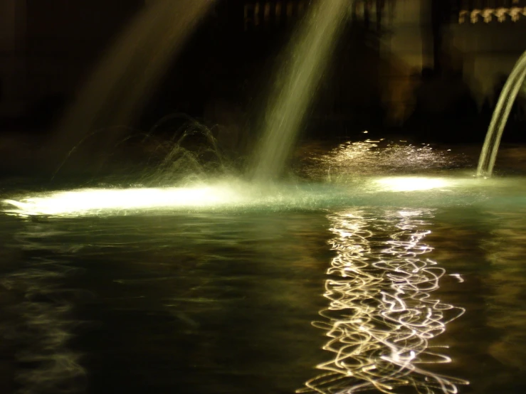 a fountain shooting water at someone while standing