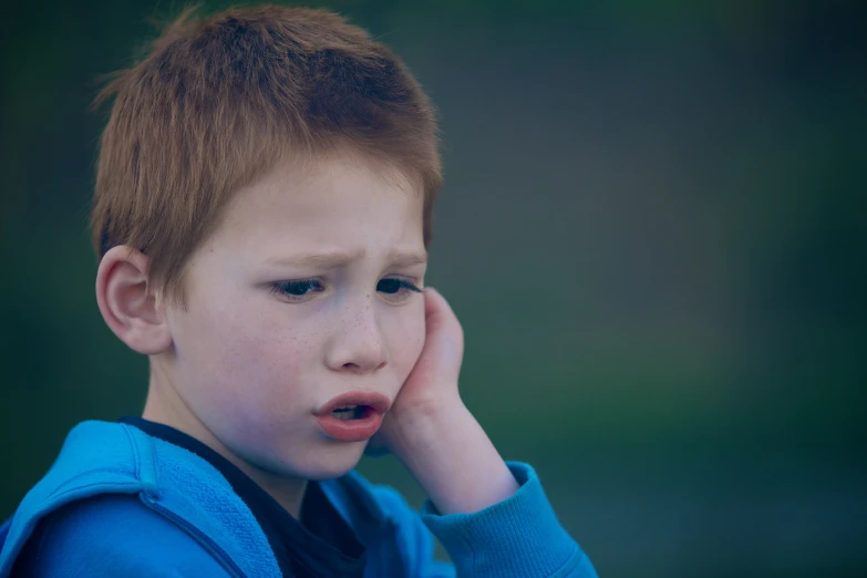 an image of a boy with a sad look on his face