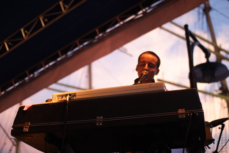 the man is smiling as he plays music on stage