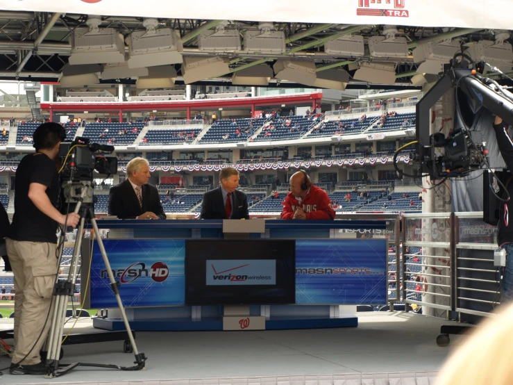 people are sitting at a tv interview on the stage