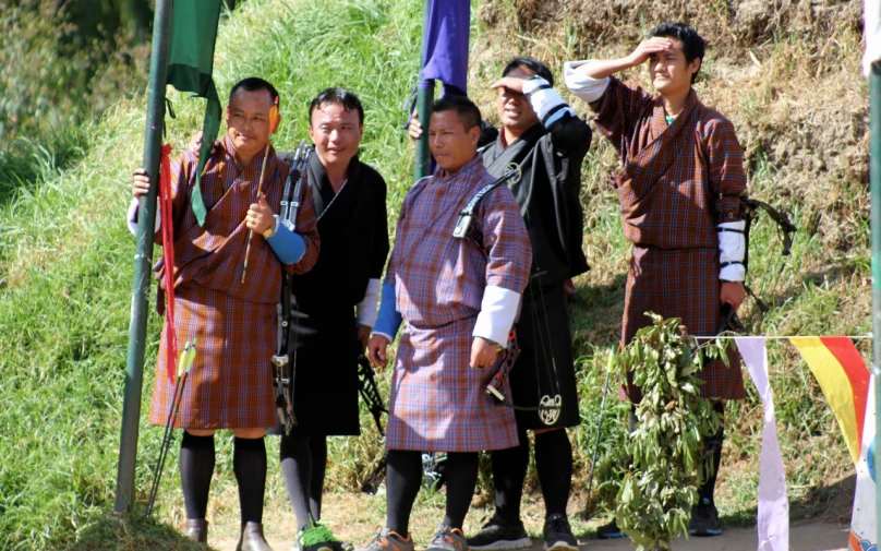 four people standing together with an object in front of them