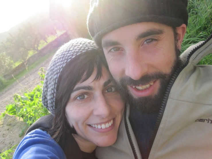 a man and woman smiling for the camera