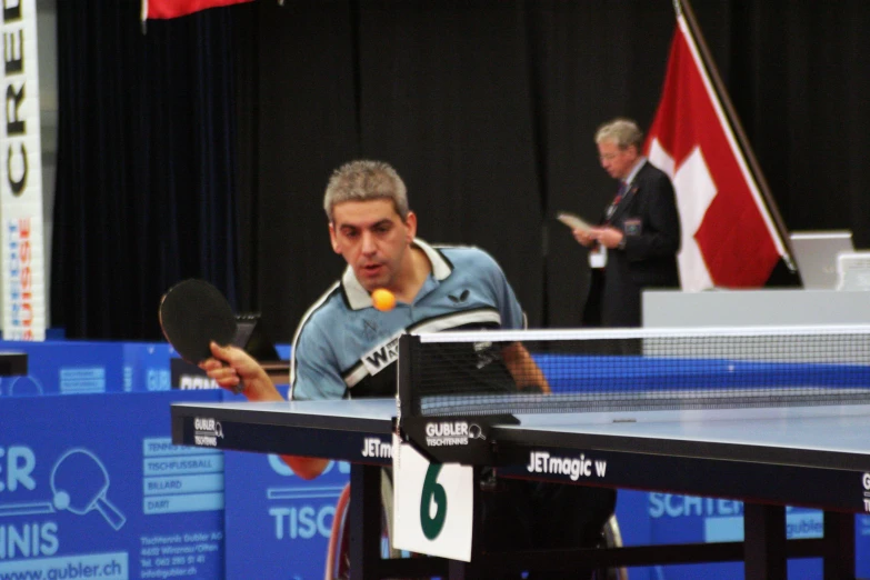 a man holding a tennis racquet on a tennis court